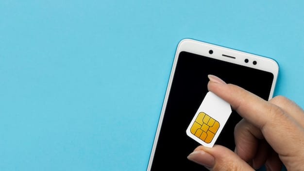 A close-up of a hand inserting a SIM card into an Android phone using a SIM ejector tool. The focus is on the SIM card and the tray.