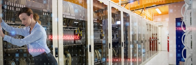 A server room with blinking lights and a technician working on a server rack. The image emphasizes the importance of data storage and backup infrastructure.